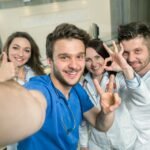 Smiling Team Of Doctors And Nurses At Hospital Taking Selfie