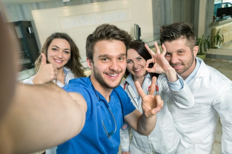 Smiling Team Of Doctors And Nurses At Hospital Taking Selfie